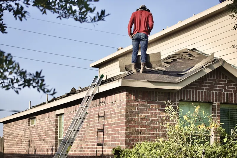 Professional roofer working on a residential roof in Orchard Island